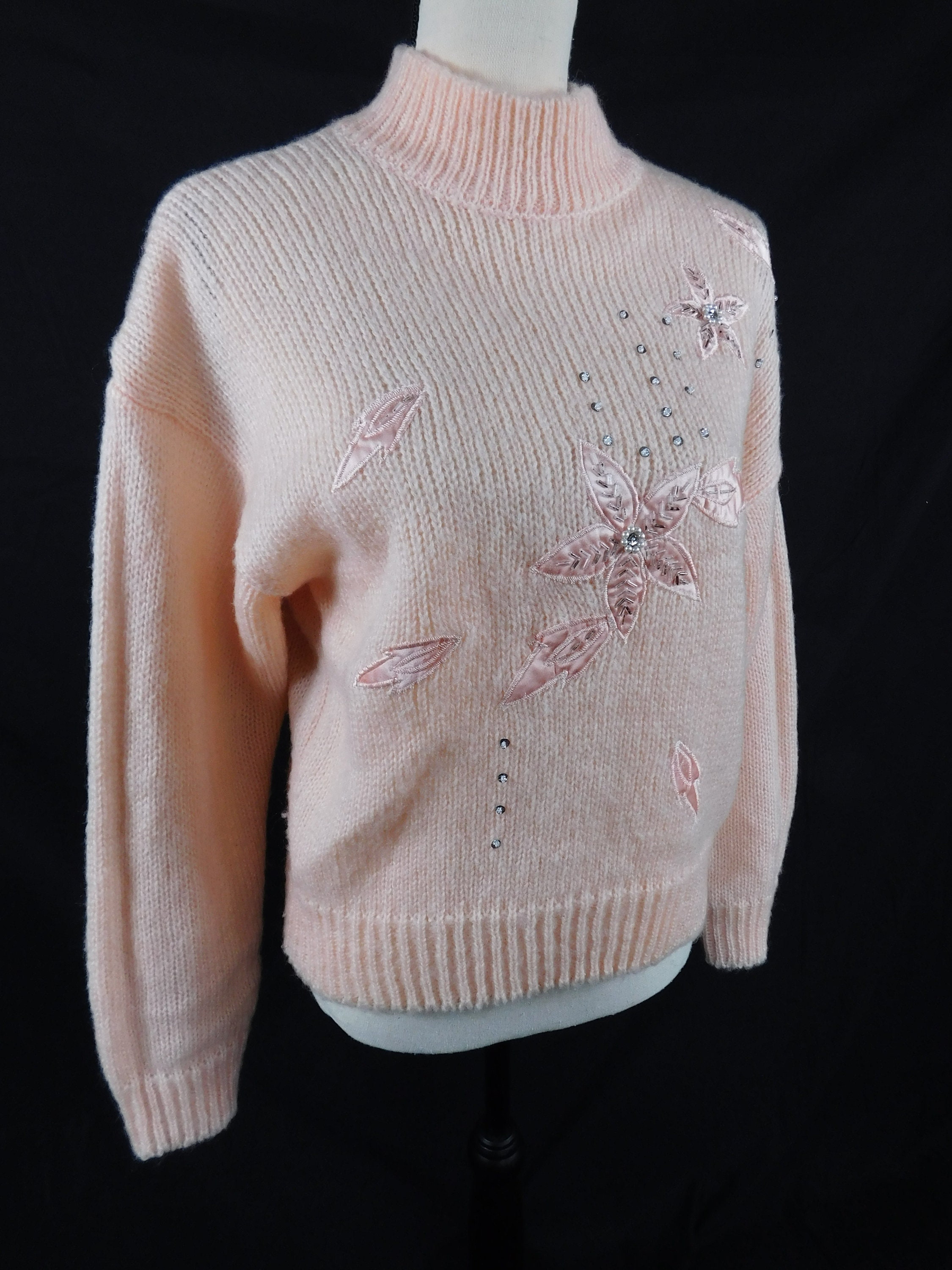Pink sweater deals with embellished collar