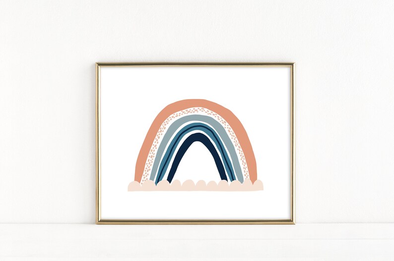 May include: A framed print of a rainbow with a peach, blue, and navy color scheme. The rainbow is depicted with a white cloud base.