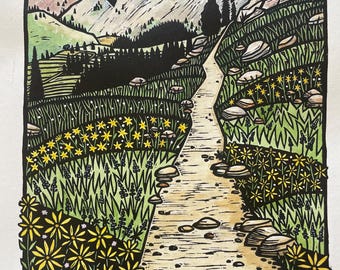 May include: A detailed woodcut print depicts a mountain trail winding through a landscape. The path is flanked by green grass and yellow wildflowers. Mountains and a cloudy sky are in the background. The artwork is in black, white, yellow, and green.