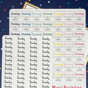 May include: Sticker sheets with the word "Recording" in different fonts and colours. One sheet features computer monitor graphics with the word "Recording" on the screen. Another sheet has the word "Recording" in a script font. Ideal for planners and journals.