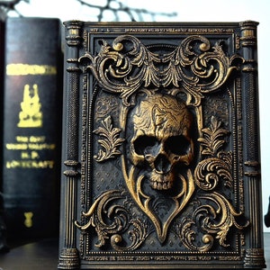 May include: A black book with gold accents and a skull design. The book is decorated with intricate floral patterns and has a gothic aesthetic.