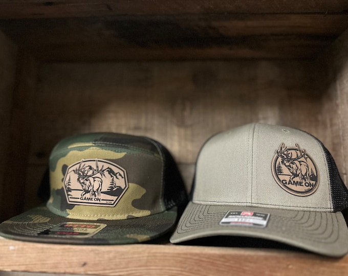 Game On Herd Bull hats. 7panel camo or trucker (snap back hat)