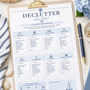 May include: A white paper declutter checklist on a wooden clipboard with a gold clip. The document features blue text and icons, organised into sections for kitchen, pantry, living room, bedrooms, closets, bathrooms, garage, and miscellaneous areas.