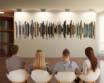 May include: A large wall art installation composed of numerous vertical wooden slats of varying lengths and widths. The slats feature a color palette of black, dark blue, light green, and natural wood tones, arranged in a rhythmic, linear pattern.