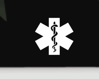 May include: A black surface featuring a white Star of Life emblem. The symbol consists of a six-pointed star with a central rod entwined by a single snake, representing the medical caduceus, centred against the solid black background.