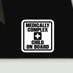 May include: A square white sticker with rounded corners and a thick black border. The text reads MEDICALLY COMPLEX in black, followed by a black square containing a white plus sign, and the text CHILD ON BOARD in black at the bottom.