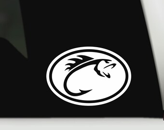 May include: White oval sticker featuring a stylized black fish design with a hook. The fish is depicted with a curved body and open mouth, set against a black background. The sticker is likely for fishing enthusiasts.