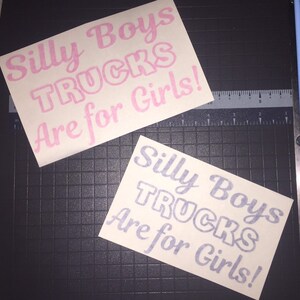 thumbnail interactive-video image 1 of Silly Boys Trucks Are For Girls - Black License Plate Frame - Sticker Connection 1 of 6