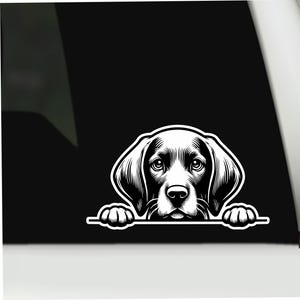 May include: A black and white vinyl decal featuring a stylized illustration of a dog with floppy ears and large eyes, peering over a horizontal line with its front paws visible. The design uses bold lines and shading to create a graphic effect.