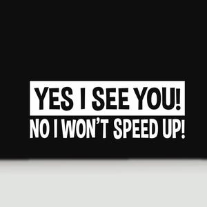May include: A white vinyl decal sticker featuring the bold black text YES I SEE YOU! inside a rectangular box, followed by the text NO I WON'T SPEED UP! in a matching sans-serif font, designed for application on a smooth surface.