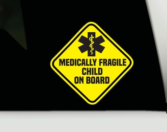 May include: A diamond-shaped yellow sticker with a black border featuring a black Star of Life symbol and the text "MEDICALLY FRAGILE CHILD ON BOARD" in bold black capital letters, designed for application on a vehicle window or surface.