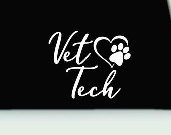 May include: White Vet Tech text with a heart and paw print design on a black background. The heart shape incorporates a paw print, symbolizing veterinary medicine and animal care. The design is suitable for stickers, apparel, or other merchandise.