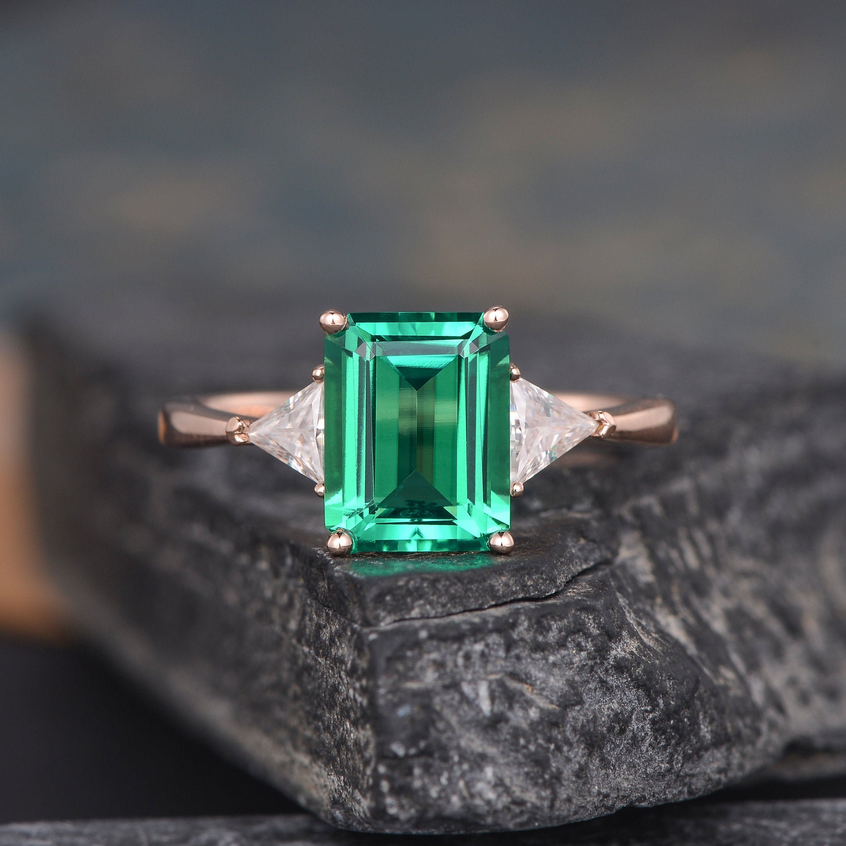 Emerald cut diamond ring with triangle on sale side stones