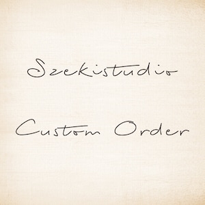 May include: A handwritten sign with the text "Szekistudio Custom Order".
