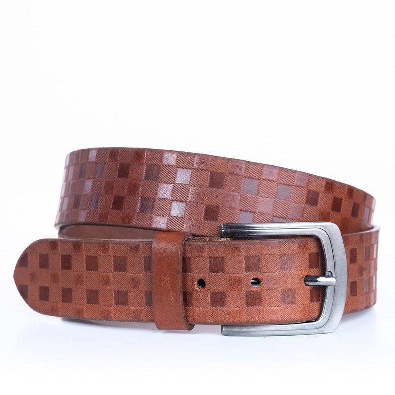 May include: A brown leather belt with a checkered pattern and a silver buckle.