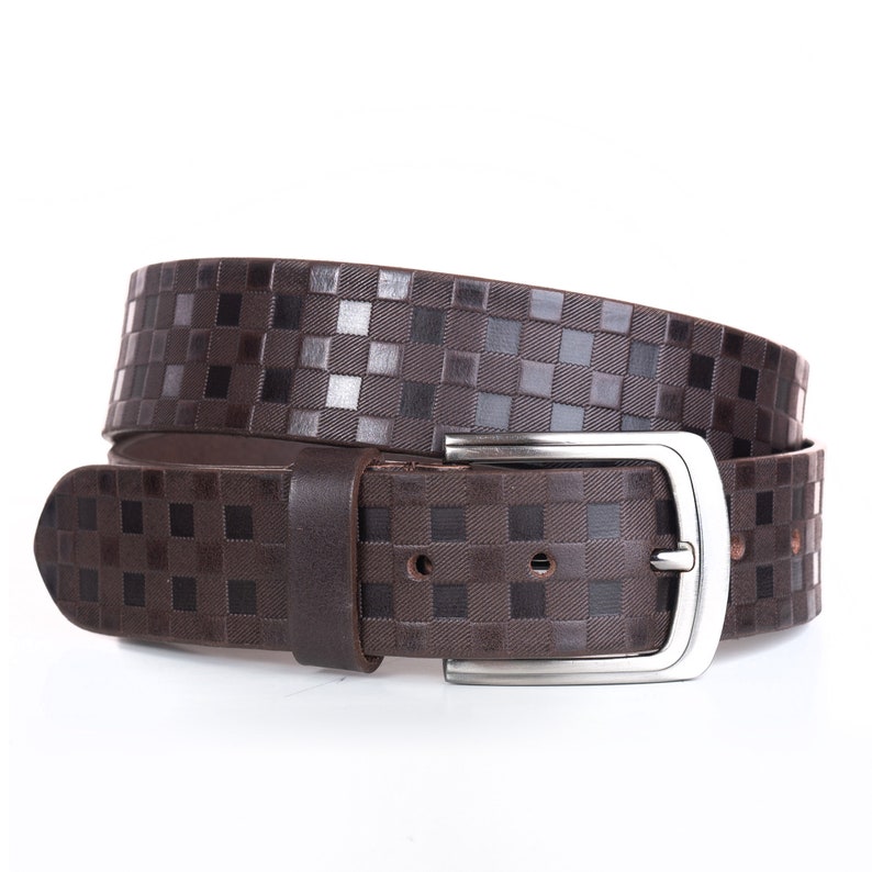 May include: A brown leather belt with a silver buckle. The belt has a checkered pattern.