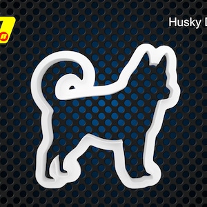 Könnte beinhalten: Weißer Plastik-Ausstecher in Form eines Husky-Hundes. Der Ausstecher befindet sich auf einem schwarzen Hintergrund mit einem Muster aus kleinen Kreisen.