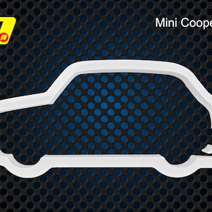 May include: A white plastic cookie cutter shaped like the side profile of a Mini Cooper S car. The design features the distinct silhouette of the vehicle with wheels and windows. The text Mini Cooper S is printed in the upper right corner.