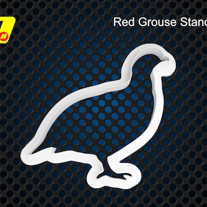May include: White plastic cookie cutter shaped like a red grouse standing with its head turned to the side. Red Grouse Standing.