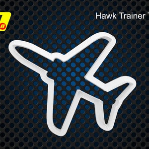 May include: White plastic cookie cutter shaped like a plane, with the text "Hawk Trainer T1A" above it. The cutter is on a black and blue background.