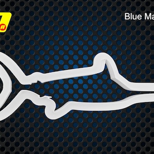 May include: White plastic cookie cutter shaped like a blue marlin fish. The cutter is on a black and blue background.