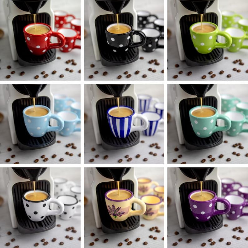 May include: Nine espresso cups with different polka dot patterns. The cups are white with black, red, blue, green, purple, and yellow polka dots. The cups are arranged in a grid pattern with a coffee machine in the background.