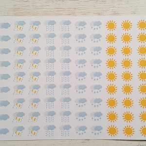 May include: A sheet of weather-themed stickers with a variety of designs, including clouds, lightning bolts, raindrops, and sunshine. The stickers are arranged in rows on a white background. The text "HLSticker Creations" is printed in the bottom right corner.