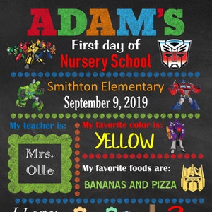 May include: A chalkboard-style sign with the name "ADAM'S" in colourful letters. It includes the text "First day of Nursery School," school details, and "September 9, 2019." The sign also features Transformers characters, favourite colour, foods, and age.