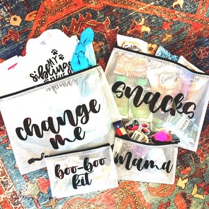 May include: Four clear mesh zippered bags with black lettering. The bags are labeled "change me", "boo-boo kit", "mama", and "snacks".