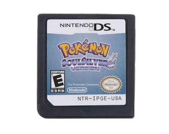 May include: A black Nintendo DS game cartridge for Pokémon SoulSilver Version. The label features the game title in purple and yellow text, an ESRB Everyone rating, the Nintendo logo, an official seal, and the product code NTR-IPGE-USA.