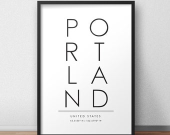 May include: Black and white typography print with the word "PORTLAND" in vertical columns. The text "UNITED STATES" and the coordinates "45.5155° N | 122.6793° W" are printed below the word.