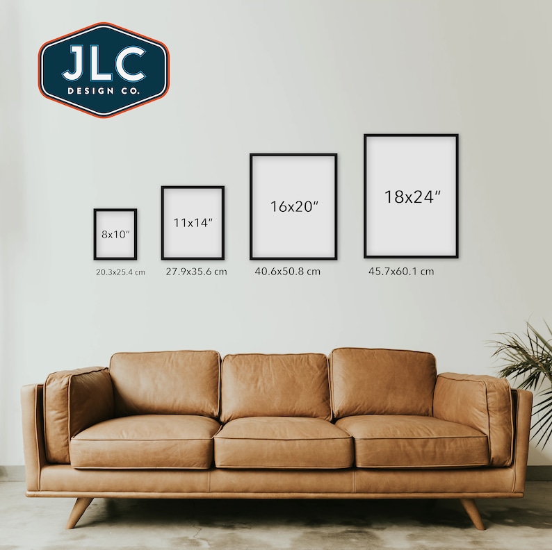 May include: Four black picture frames of different sizes on a white wall above a brown leather couch. The frames are labeled with their dimensions in inches and centimeters. The frames are 8x10 inches, 11x14 inches, 16x20 inches, and 18x24 inches.
