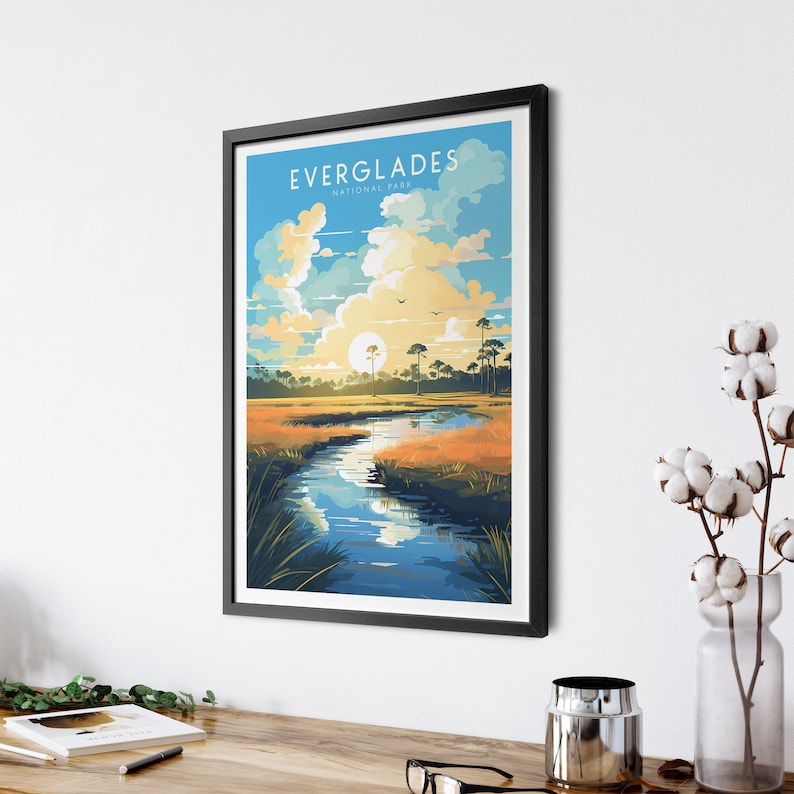 May include: A vintage-style poster with a blue sky, white clouds, and a sun setting over a river in a swamp. The text "EVERGLADES NATIONAL PARK" is at the top of the poster.