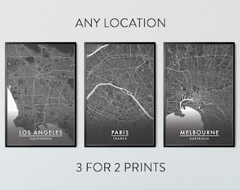 May include: Three framed monochrome city map prints, showcasing Los Angeles, Paris, and Melbourne. The prints are displayed on a white wall, with the text "ANY LOCATION" and "3 FOR 2 PRINTS".