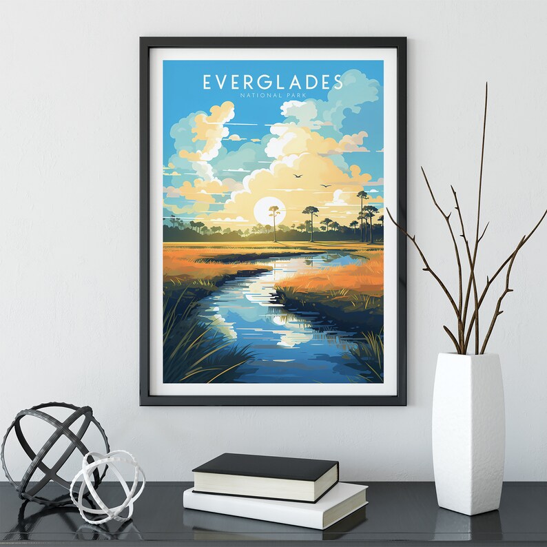 May include: A framed poster with a colorful illustration of a river winding through a grassy marsh with a sunset sky and the text "Everglades National Park".