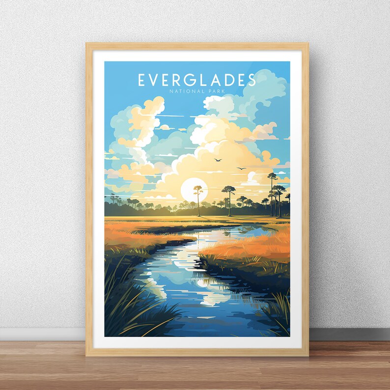 May include: A vintage-style poster with a blue sky and white clouds. The poster features a river winding through a grassy field with trees in the background. The text "EVERGLADES NATIONAL PARK" is at the top of the poster.