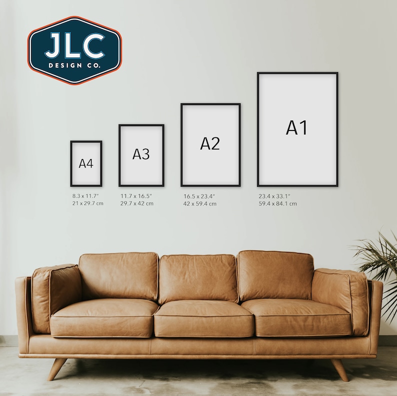 May include: Four black picture frames of different sizes labeled A1, A2, A3, and A4. The frames are hanging on a white wall above a brown leather couch. The frames are labeled with their dimensions in inches and centimeters.