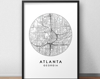 May include: Black and white map print of Atlanta, Georgia. The map is in a circle and shows the city streets and roads. The text "Atlanta, Georgia" is below the map.