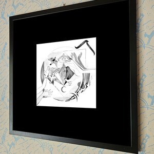 May include: Black and white drawing of a woman with her arms outstretched, surrounded by abstract shapes and a crescent moon. The drawing is framed in a black frame.