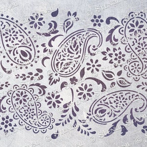 May include: A stencil featuring a paisley pattern with intricate details. The design includes multiple paisley shapes, floral elements, and small dots. The stencil is made of a durable material and is suitable for use with various crafting techniques.