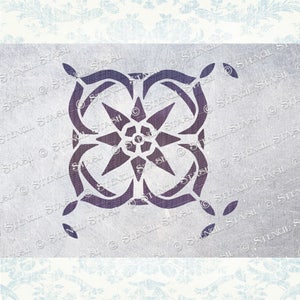 May include: A purple stencil with a geometric design featuring a star in the centre. The stencil is on a light grey background.