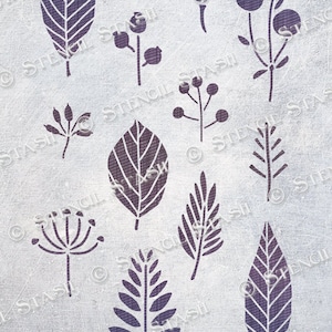 May include: A stencil sheet featuring a variety of leaf and flower designs. The designs are in a dark purple colour and are arranged in a random pattern on a white background.