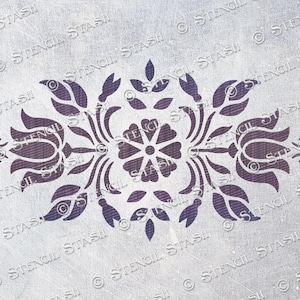 May include: A stencil with a symmetrical design featuring a central flower with four petals and four surrounding floral motifs. The design is in a dark purple colour on a white background.