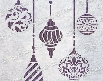 May include: A stencil featuring four different ornament designs. The ornaments are all suspended from strings and have intricate patterns. The stencil is made from a durable material and is ideal for creating unique festive decorations.