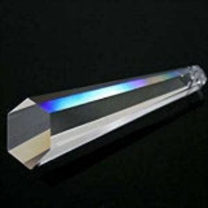 May include: A clear glass prism with a hexagonal base and a pointed tip. The prism is about 10 inches long and has a rainbow effect when light shines through it.