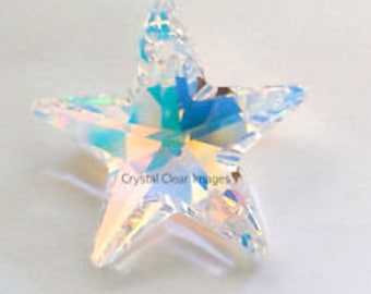 May include: A clear iridescent star-shaped crystal prism with a faceted design.
