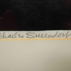 May include: Artwork with a black rectangular shape at the top and a light-colored background. The artist's signature, "Charles Surendorf," is written in pencil-like script at the bottom of the artwork.