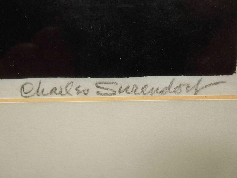 May include: Artwork with a black rectangular shape at the top and a light-colored background. The artist's signature, "Charles Surendorf," is written in pencil-like script at the bottom of the artwork.