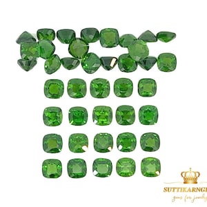 May include: A collection of 25 green gemstones, cut into square cushion shapes. The gemstones are arranged in rows, with the top row slightly offset from the bottom rows.