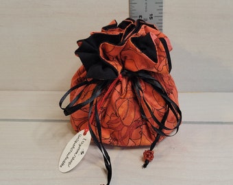 Travel Pouch:  orange/ black floral print - also great for small crafts, DnD dice, jewelry, makeup, golf tees, charger cords.